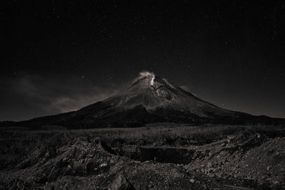 Scenic view of snowcapped mountains against sky at night