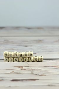 Close-up of text on beach against clear sky