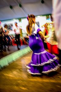 Midsection of woman dancing at nightclub