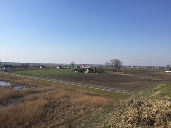 Scenic view of agricultural field against clear sky
