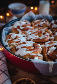 Close-up of homemade cinnamon rolls with cream cheese icing,on wooden background