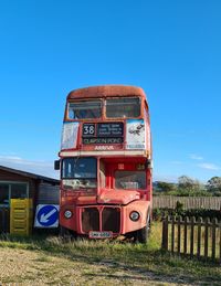 Train on field against clear blue sky