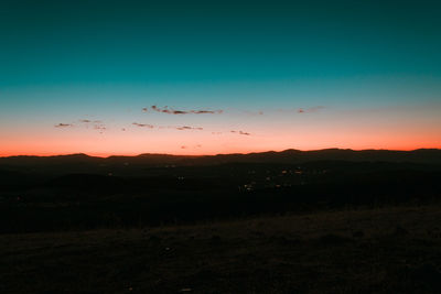 Scenic view of silhouette landscape against sky at sunset