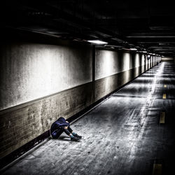 Low section of man standing on tiled floor