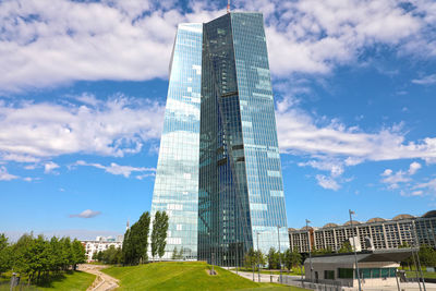 Low angle view of buildings against cloudy sky