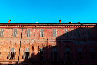 Low angle view of historic building against clear blue sky