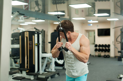 Young man exercising in gym