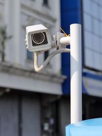 Close-up of security camera against wall