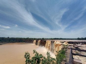 Scenic view of waterfall against sky