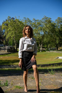 Portrait of young woman standing on field