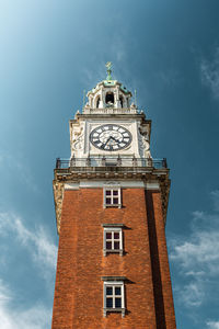 Low angle view of clock tower against sky