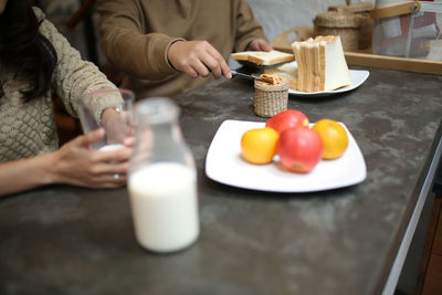 Midsection of woman preparing food on table