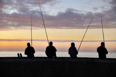 Silhouette people at sunset