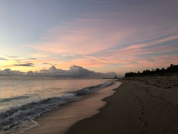 Scenic view of beach against sky during sunset