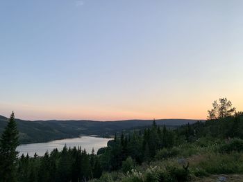 Scenic view of mountains against clear sky during sunset