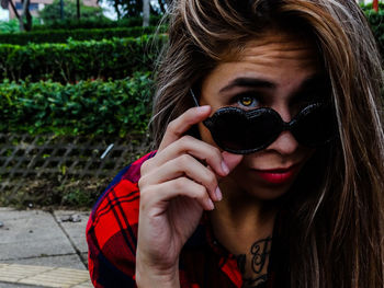 Close-up portrait of woman wearing sunglasses