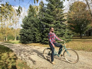 Full length of man with bicycle in park
