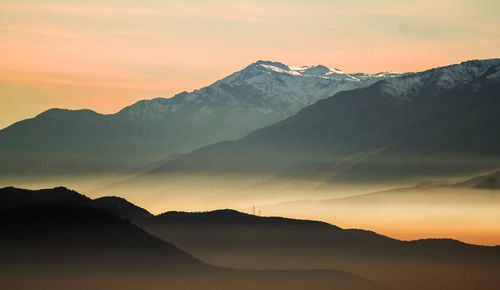 Scenic view of mountains against sky during sunset