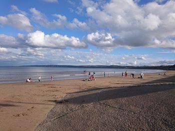 People on beach against sky