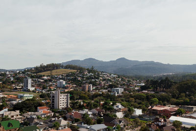 High angle view of townscape and mountains against sky