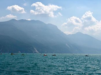 Scenic view of sea and mountains against sky