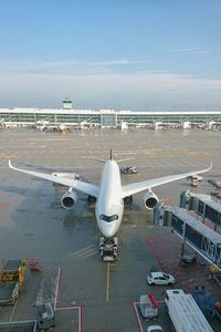 High angle view of airplane on airport runway against sky