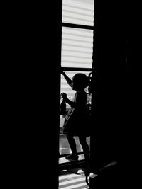 Silhouette man standing in corridor