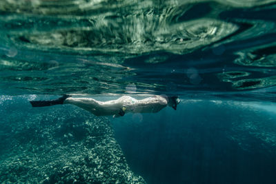 Adult female snorkeling in clear water in hawaii