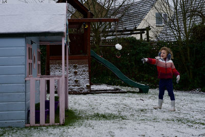 Full length of girl standing in park during winter