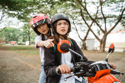 Portrait of boy riding bicycle on road