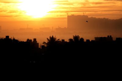 Silhouette of city during sunset