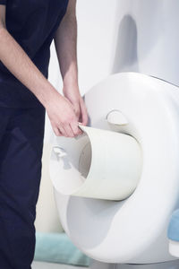 Midsection of man standing by mri scanner