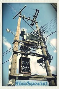 Low angle view of power lines against sky