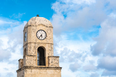 Low angle view of clock tower against sky