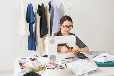 Portrait of woman wearing eyeglasses on table