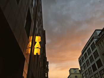 Low angle view of buildings against cloudy sky