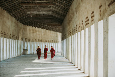 Rear view of people walking in corridor