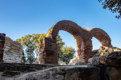 Low angle view of old ruins against clear sky