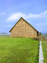 House on field against sky