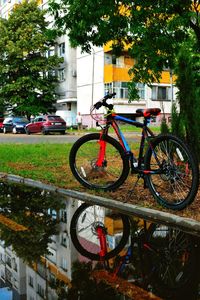 Bicycle against building in city