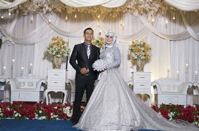 Couple holding flower bouquet