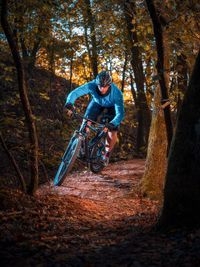 Man riding bicycle in forest