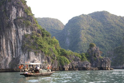 Scenic view of boats in lake against mountain range