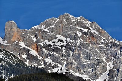 Scenic view of snowcapped mountains against clear blue sky