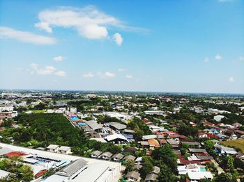 High angle view of townscape by sea against sky
