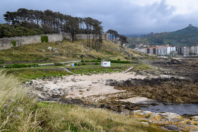 View of the beach of os frades in baiona - spain. small beach located next to the fortress 