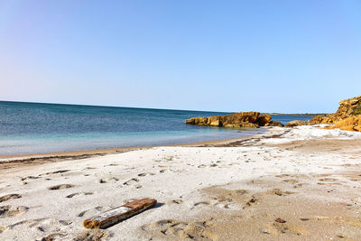 Scenic view of beach against clear sky