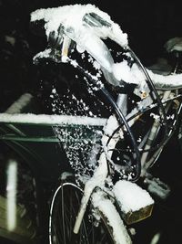 Close-up of frozen bicycle during winter