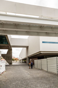 Rear view of people walking on building