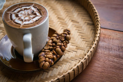 High angle view of coffee beans in glass on table